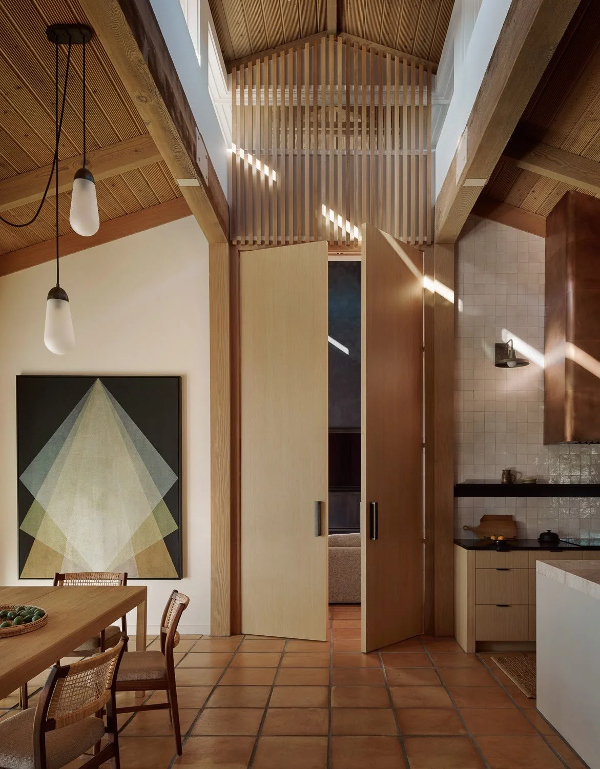 A geometric painting by Gonzalo Lebrija in the Sonoma dining room, beside the kitchen, above Saltillo tile floors
